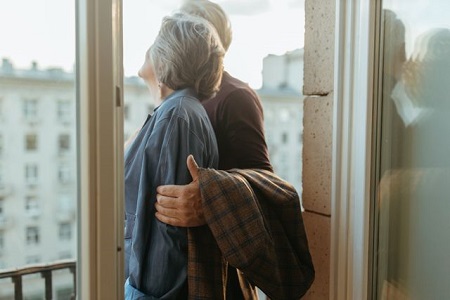 Couple mature complice près d'une fenêtre